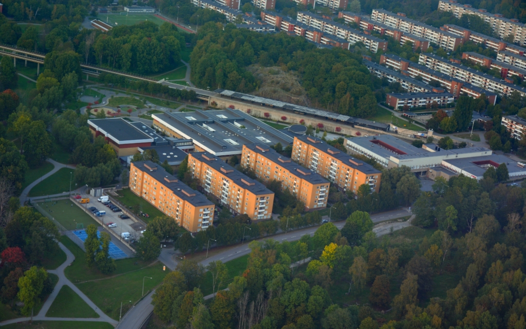 Flygfoto i färg över modern urban bebyggelse.